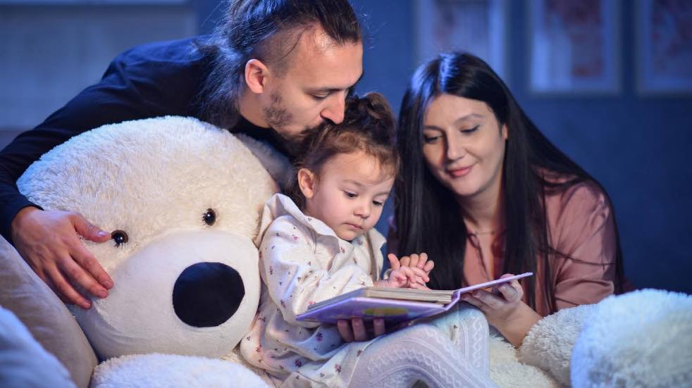 Parents reading child a bedtime story